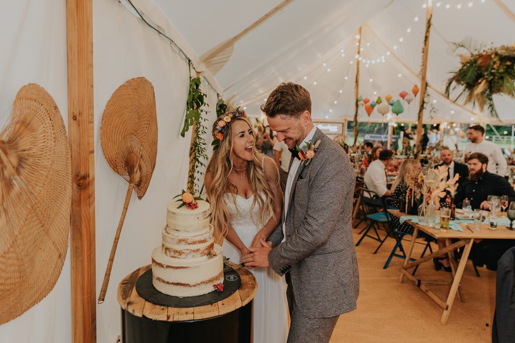 Themed marquee décor with rustic wooden tables and floral arrangements.