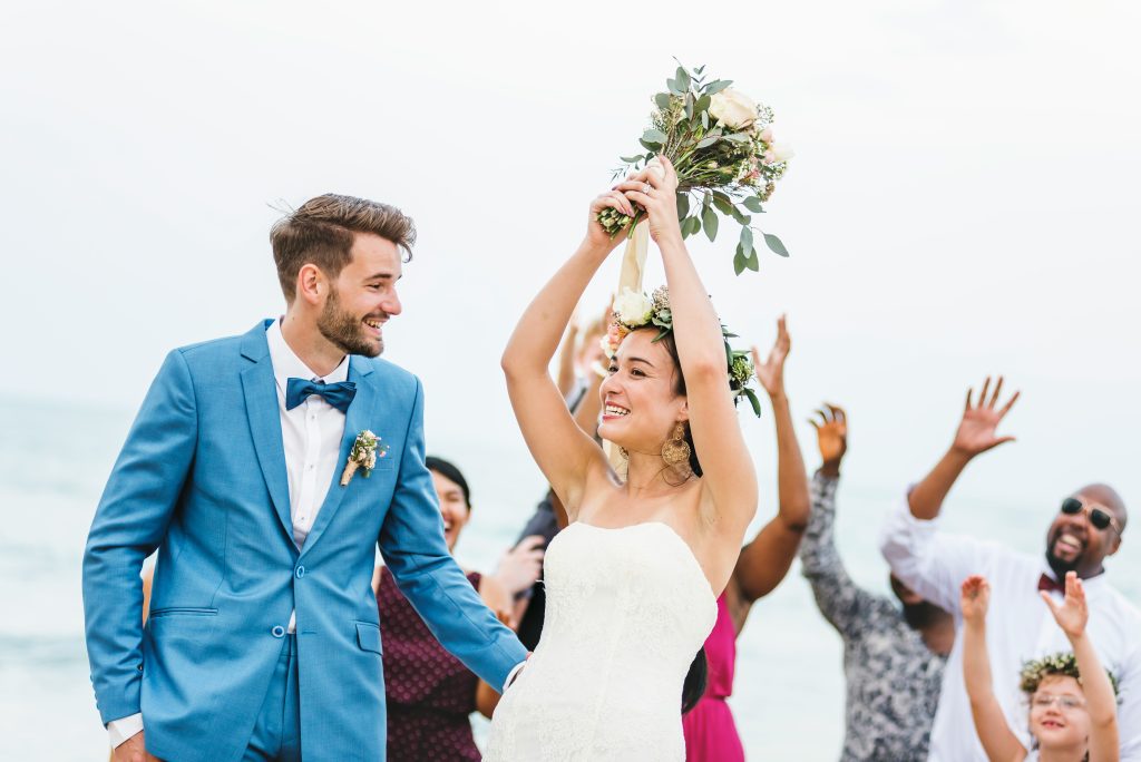 Group of excited Guests reaching for the bouquet