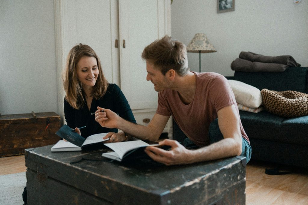 Couple planning with notebooks and coffee
